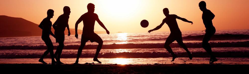 playing soccer on the beach
